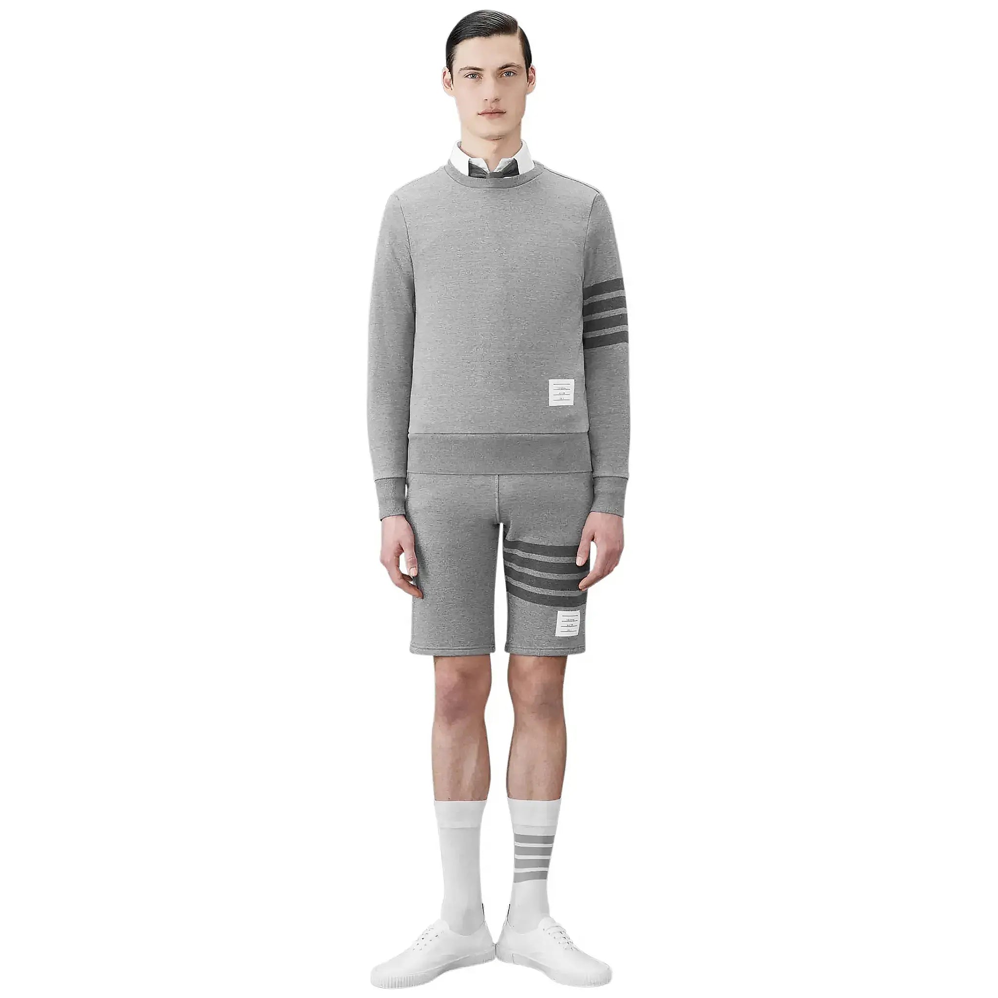 Model view of Thom Browne Classic Loopback 4-Bar Grey Sweat Shorts MJQ012H-00535-068